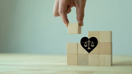 Concept of justice and love with wooden blocks forming scales