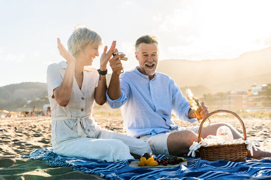 Beautiful happy senior couple dating at the seaside during summertime