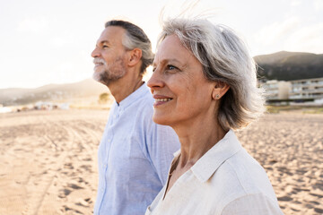 Beautiful happy senior couple dating at the seaside during summertime