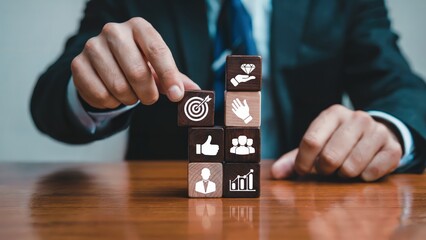 Businessman sets targets with wooden cubes for business growth strategy