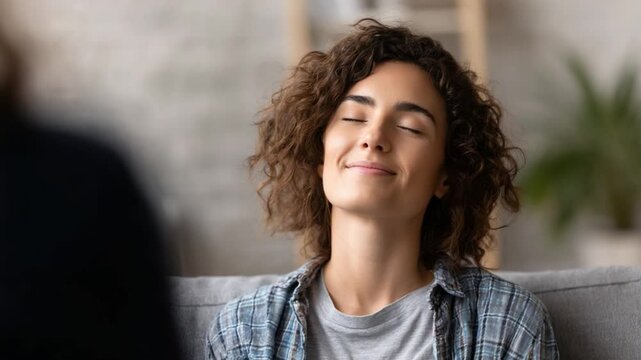 Serenity and Relaxation: A moment of peace and inner calm is captured as a woman closes her eyes, embraces tranquility. Ideal for illustrating mindfulness.