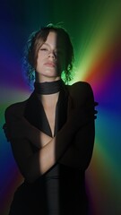 Woman in rainbow spotlight with dramatic contrast