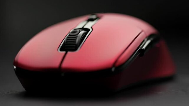 Close-up of a pink computer mouse on a dark background