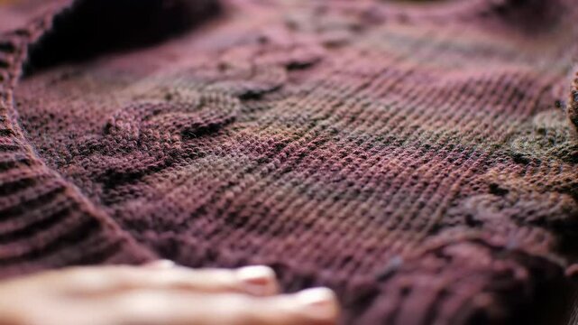 Close-up of a knitted blanket in dim light for texture background