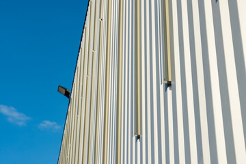 Vue sur une façade en tôle crème équipée de supports métalliques prêts à accueillir des...