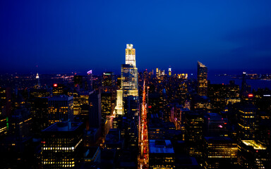 Fototapeta premium USA, New York City, New York, Manhattan, Aerial view of illuminated skyline at night.