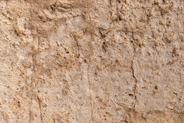 Close-up of rough textured stone wall surface with natural patterns