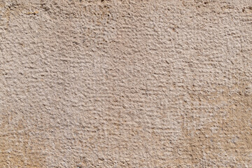 Textured beige stone surface with subtle grid pattern