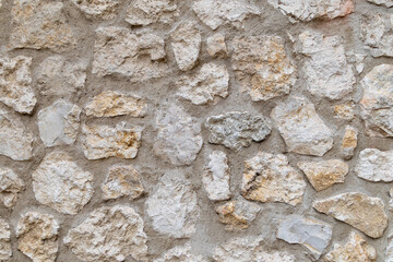 Rough stone wall texture with beige and white tones