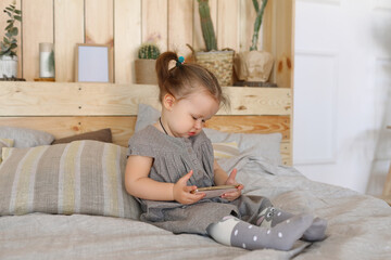 Little girl on bed in bedroom