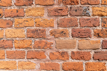 Rustic red brick wall texture with varied shades and rough surface