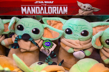 Naklejka premium Grogu Plush Toys in an Arcade Machine