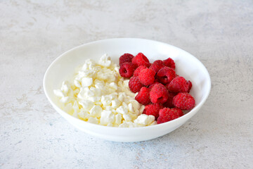 Fresh Cottage Cheese with Raspberries in a White Bowl A Healthy Breakfast