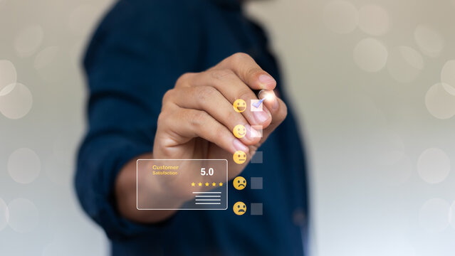 Hand selecting positive emoji in customer satisfaction survey with five-star rating, feedback review, and digital customer experience evaluation concept.