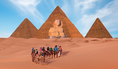 A Group of tourist riding a camel - Camels in Giza Pyramid Complex - Cairo, Egypt