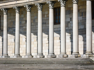 Stone colonnade and stairs detail. Classical pillars row in a building facade