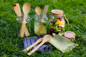 Picnic Scene with Wooden Spoons and Fresh Salad Jars
