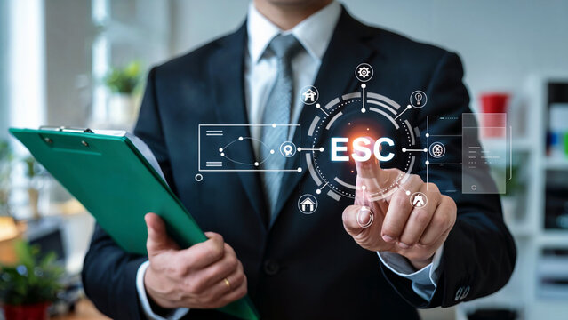 Businessman interacts with a futuristic digital interface displaying esc acronym and various icons representing business and technology concepts
