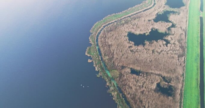 Aerial view of lake and nature area Schoterveld in mist, Flevoland, Netherlands