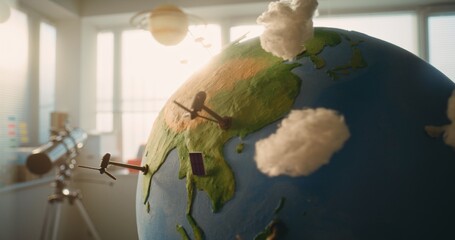Modern STEM Classroom: Close Up of Rotating Earth Model with Miniature 3D Models of Wind Turbines...