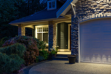 Entrance of luxury house with nice spring blossom landscape at night in Vancouver, Canada, North...