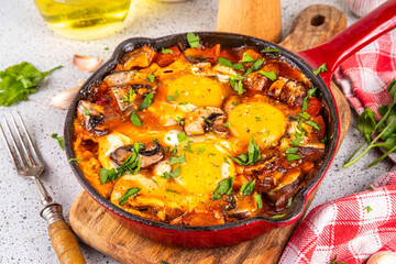 Mushroom Shakshuka. Tasty breakfast shakshuka with baked fried eggs, vegetables - tomato, onions, bell pepper and a lot of champignon mushrooms