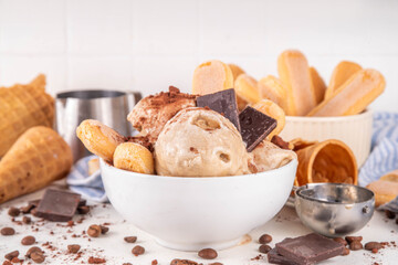 Tasty tiramisu ice cream with coffee syrup, savoyardi cookies, chocolate, cocoa powder. Portioned...