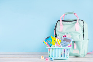 Back to school sale and shopping concept. Variety of school stationery in shopping basket pencils,...