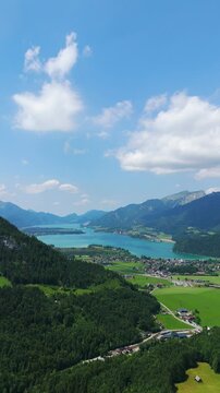 Lake Wolfgangsee and Strobl Town in a sunny day. Aerial vertical