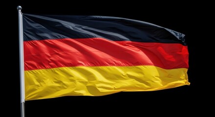 Obraz premium National Flag of Germany Flying Proudly Against a Dark Sky