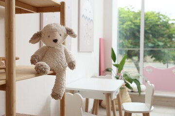 Cute toy on shelf in stylish playroom. Interior design