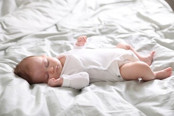 Cute sweet newborn baby sleeping on bed