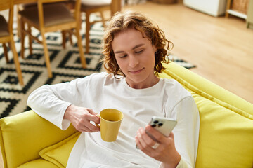 Relaxing at home with a warm cup and a smartphone in hand, enjoying a peaceful moment
