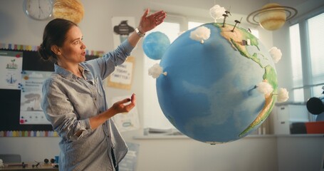 STEM Class: Female School Teacher Educating Science and Renewable Energy Sources Using Model of...