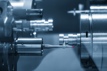The modular touch probe checking the cam shaft shaft parts on CNC lathe machine in the light blue...