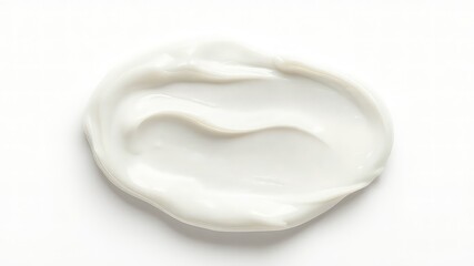 A single dollop of smooth, white lotion or cream is placed against a bright and clean white backdrop