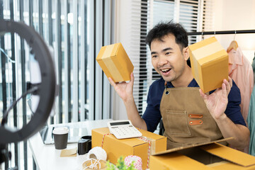 A man is selling clothes online. He has a notebook to record information. He is wearing a blue...