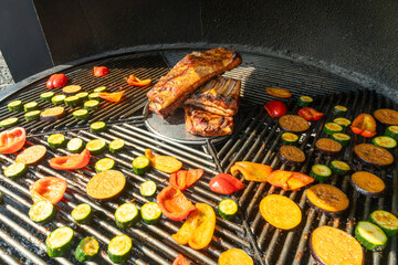 Grilled Pork Ribs And Vegetables On Barbecue. Summer Barbecue Scene With Juicy Pork Ribs And...