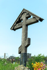 Old wooden cross standing tall in a peaceful resting place reflecting the beauty of life and the...