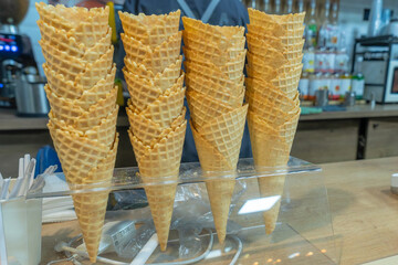 The Minimalist Beauty of Empty Waffle Cones Awaiting Sweet Creations. A Beautifully Arranged Display of Waffle Cones. Exploring the Textures and Colors of Ice Cream Cones in a Cozy Cafe Setting.