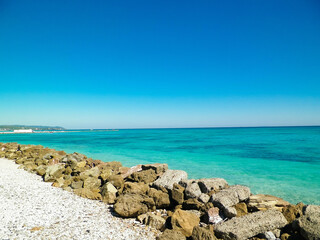 Breakwater on beach in Vada, Italy.