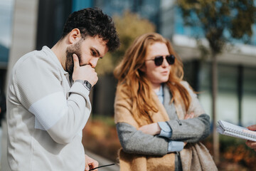 Two individuals are engaged in thoughtful conversation and reflection, captured outdoors with...
