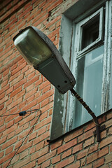 Old Soviet lantern on a house in the city