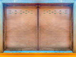 Closed steel shutter door of retro color warehouse, storage or storefront for old grunge gray metal...