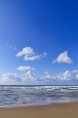 Sky and beach landscape. sky with clouds and sea with waves on a sunny day, beach in northern Spain.