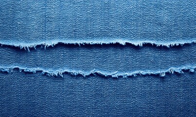 Close-up shot of textured blue denim fabric with torn, frayed edges, showing detail and material quality.
