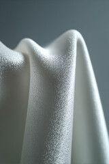 closeup of textured surface showcasing monochromatic background featuring rough silk material