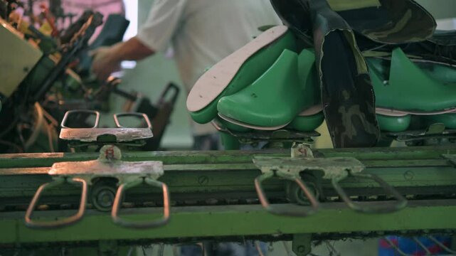 Bootmakers making shoes at a shoe factory. the process of sewing shoes in a factory. shoe manufacturing