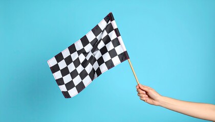 Checkered flag in hand against blue