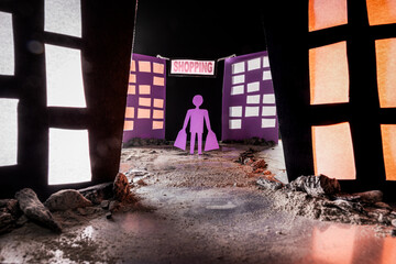 Conceptual image of a man carrying shopping bags walking on a dirt and rock-covered path through a...